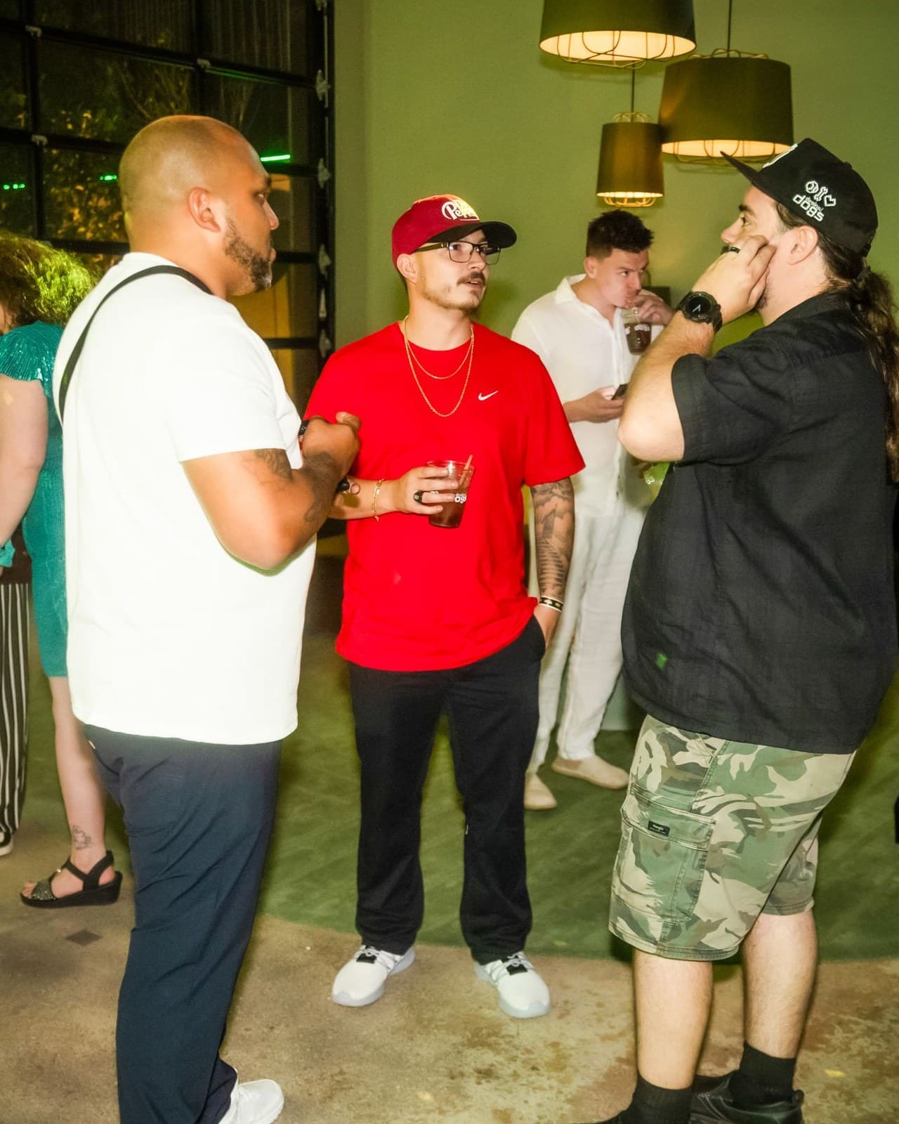 Jag (JagOBX) — Jagger Ange in a red Nike shirt and red cap Jag (JagOBX) in a red Nike shirt, red cap, and glasses, talking with friends